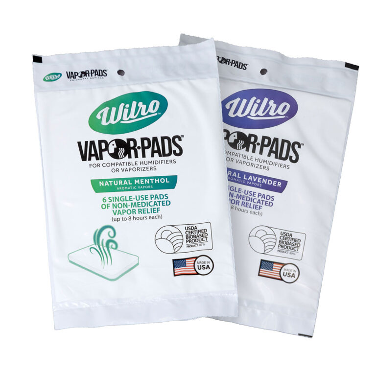Two Wilpro Combo Pack Vapor Pads stand upright—one with Natural Menthol, the other Natural Lavender. Both suit humidifiers or vaporizers, feature green and purple accents, and show USA plus USDA certified logos.