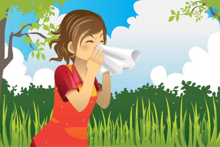 A girl wearing a red dress stands outdoors in tall grass, sneezing into a white tissue. The sky is blue with clouds, and green trees and bushes are in the background.